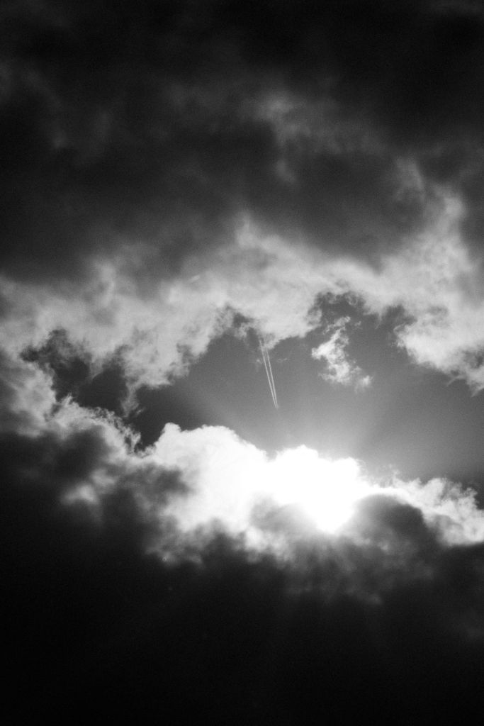 Photo by Alex Fu: https://www.pexels.com/photo/black-and-white-photo-of-sun-shining-from-behind-the-clouds-12466092/